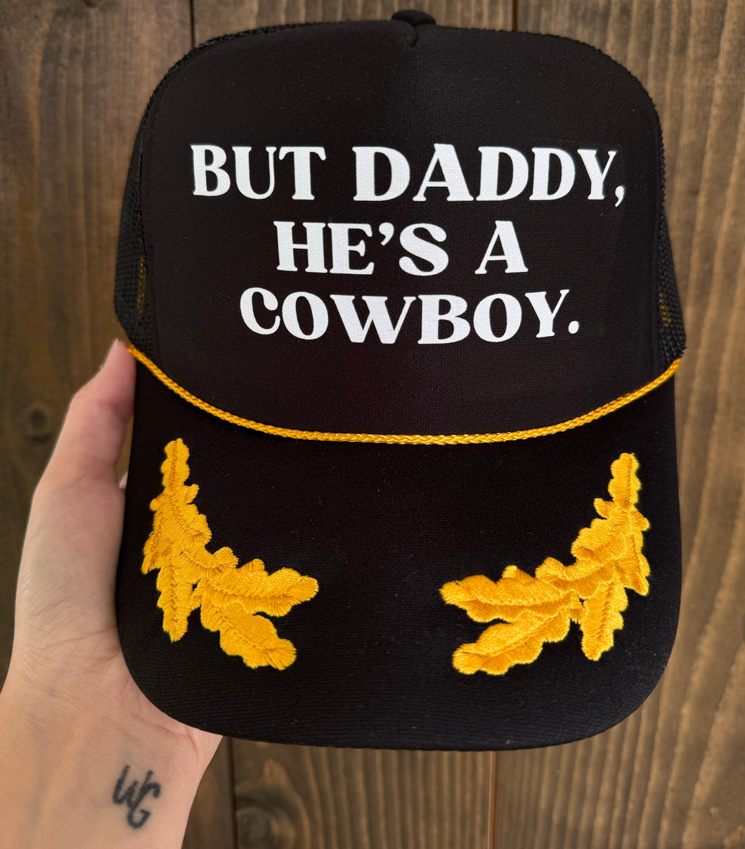 But He’s A Cowboy Trucker Hat